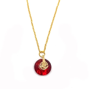 Macro shot of 14mm red crystal round pendant with gold rose accent on a fine chain
