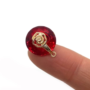 14mm round faceted red crystal pendant with golden flower inlay and hanging ring