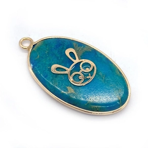 Oval blue natural stone pendant with gold tree of life and bunny accent for jewelry