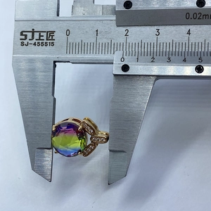 Detail view of faceted crystal pendant being measured with a digital caliper for size