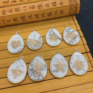 Set of 8 teardrop white turquoise stone pendants with assorted golden metal charms