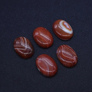 Detailed view of five oval striped red agate stones with natural white band patterns