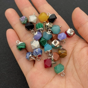Handheld display of faceted natural stone pendants with silver metal connectors and rings