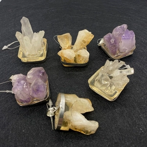 Macro view of irregular natural crystal cluster pendants in amethyst and citrine styles