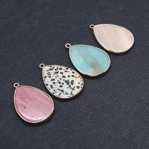 Detailed close-up of water drop natural stone pendants with elegant gold metal edging