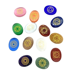 Polished oval natural stones and opal set with golden engraved chakra symbols