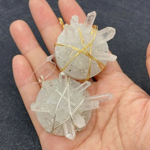 Detail of natural white crystal cluster pendants with gold and silver wire wrapping