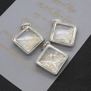 Natural white crystal diamond-shaped pendant with textured silver bezel and bail
