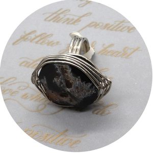 Handmade wire wrapped ring featuring an irregular black agate natural stone in silver finish