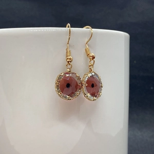 Macro shot of 13mm evil eye crystal pendants with copper gold plating for DIY jewelry