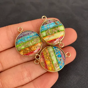 Macro detail of three colorful striped emperor stone pendants with gold metal frames