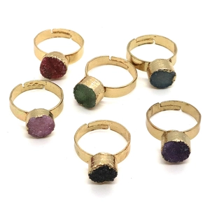 Detailed view of six colorful druzy quartz crystal rings with gold plated open bands