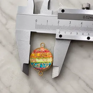 Rainbow emperor stone connector pendant measuring 18mm diameter with gold metal frame