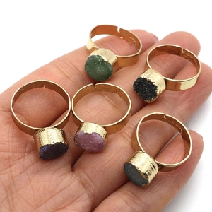 Set of five adjustable gold rings featuring natural raw crystal clusters in various colors