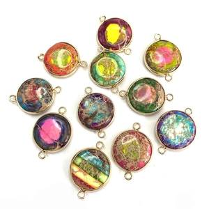 Flat lay of colorful natural emperor stone pendants with gold plated double connectors