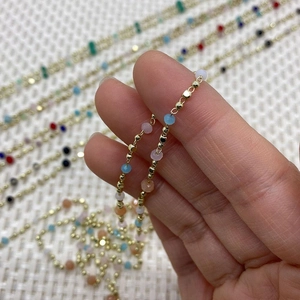 Macro shot of gold bead chain with colorful faceted natural stones for DIY jewelry