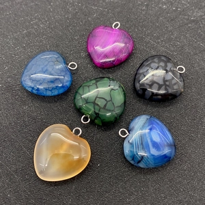 Close-up of heart-shaped striped agate pendants in six various colors for DIY jewelry