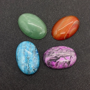 Polished oval gemstone cabochons including red agate and aventurine for DIY jewelry