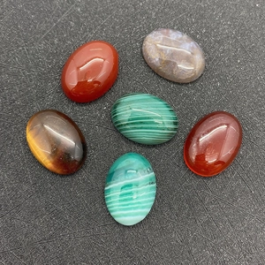 Detailed view of six 13x18mm oval tiger eye and agate cabochons on black background