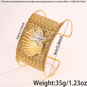 Detailed close-up of woven gold cuff bracelet featuring starfish and seashell accents