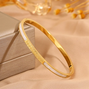 Elegant gold stainless steel bangle with white shell inlay and Greek key pattern