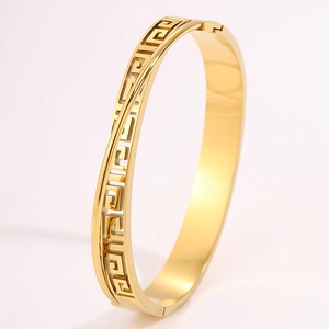 Detailed macro view of the gold-plated stainless steel cuff bracelet with Greek meander motif