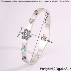 Detail view of silver stainless steel bangle with gemstone flower and side buckle closure