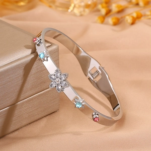 Macro detail of silver stainless steel bangle with colorful crystals and spring closure