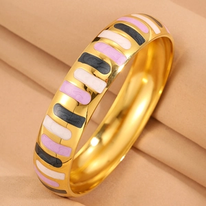 Macro detail of wide gold-plated stainless steel bangle with colorful enamel inlays