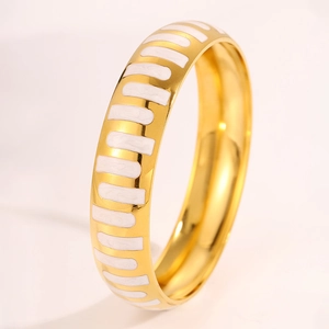 Detailed view of wide gold stainless steel bangle featuring elegant white enamel stripes