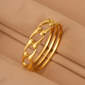 Detail view of gold hollow teardrop stainless steel bangle with polished finish