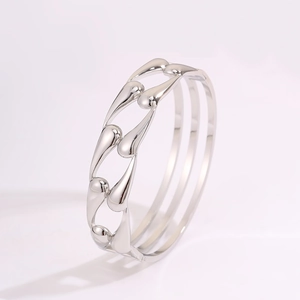 Detail showing hollow teardrop design and mirrored finish of the silver stainless steel bangle