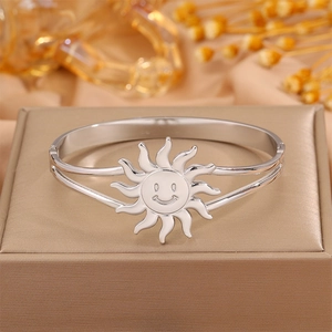 Detailed macro view of silver sun smiley face bangle with hollow bracket design on jewelry box
