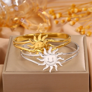 Polished sun smile face bangle in gold and silver finish with hinged closure detail