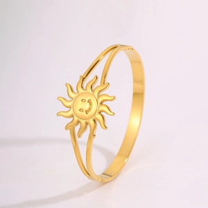 Detailed close-up of a gold sun smiley face bangle with a creative double-line hollow band
