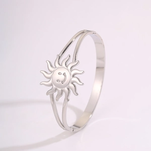 Macro shot of silver stainless steel sun smile clasp detail on a dual-line cuff bracelet