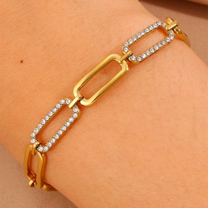 Detailed close-up of gold-plated titanium bracelet with shimmering inlaid zircon stones