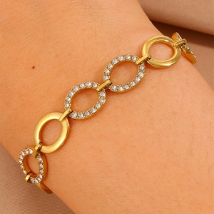 Detail of gold oval link bracelet with alternating polished and diamond-set links