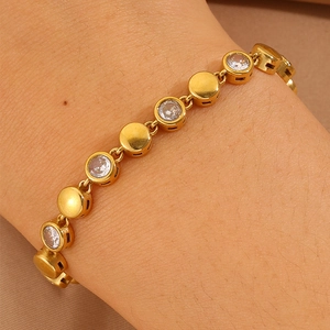 Close-up of a gold-plated bracelet with zircon stones worn on a woman's wrist