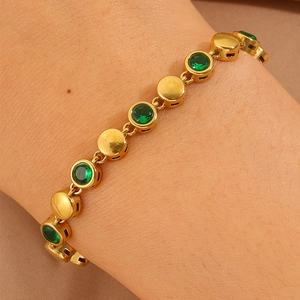 Close-up of a 18k gold-plated stainless steel bracelet featuring green zircon beads