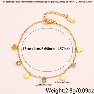 Detailed view of gold stainless steel bracelet with clover charm and sparkling zircon