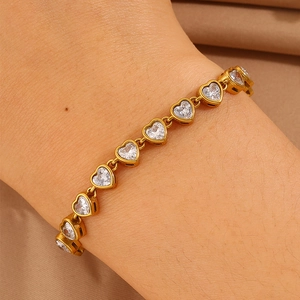 Close-up of gold titanium steel bracelet with sparkling heart-shaped zirconia stones