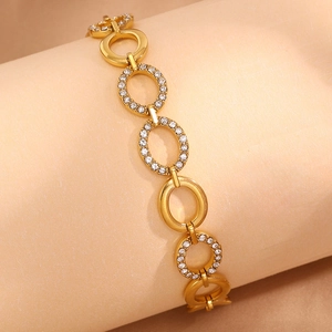 Macro detail of 18k gold plated stainless steel bracelet with oval rhinestone pave links