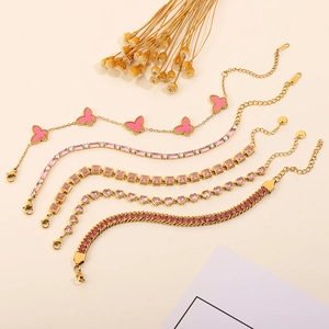 Detail of five-piece pink zircon heart and butterfly bracelet set in gold finish