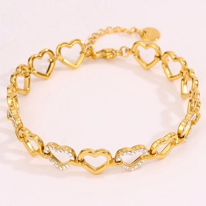 Detail of gold heart link bracelet with sparkling rhinestones and adjustable extender chain