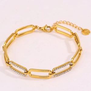 Close-up of gold-plated rectangular link bracelet with shimmering crystal-set accents