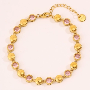 Close-up of golden zirconium bracelet with pink stones and S.Steel engraved tag