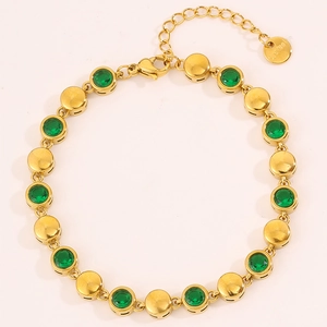 Detail of gold titanium steel bracelet featuring green zircon gems and s.steel tag