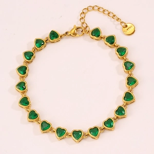 Detail of gold-plated stainless steel heart bracelet with 16 green zirconia stones