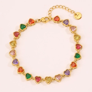 Macro detail of rainbow heart gemstones set in a gold-plated stainless steel bracelet